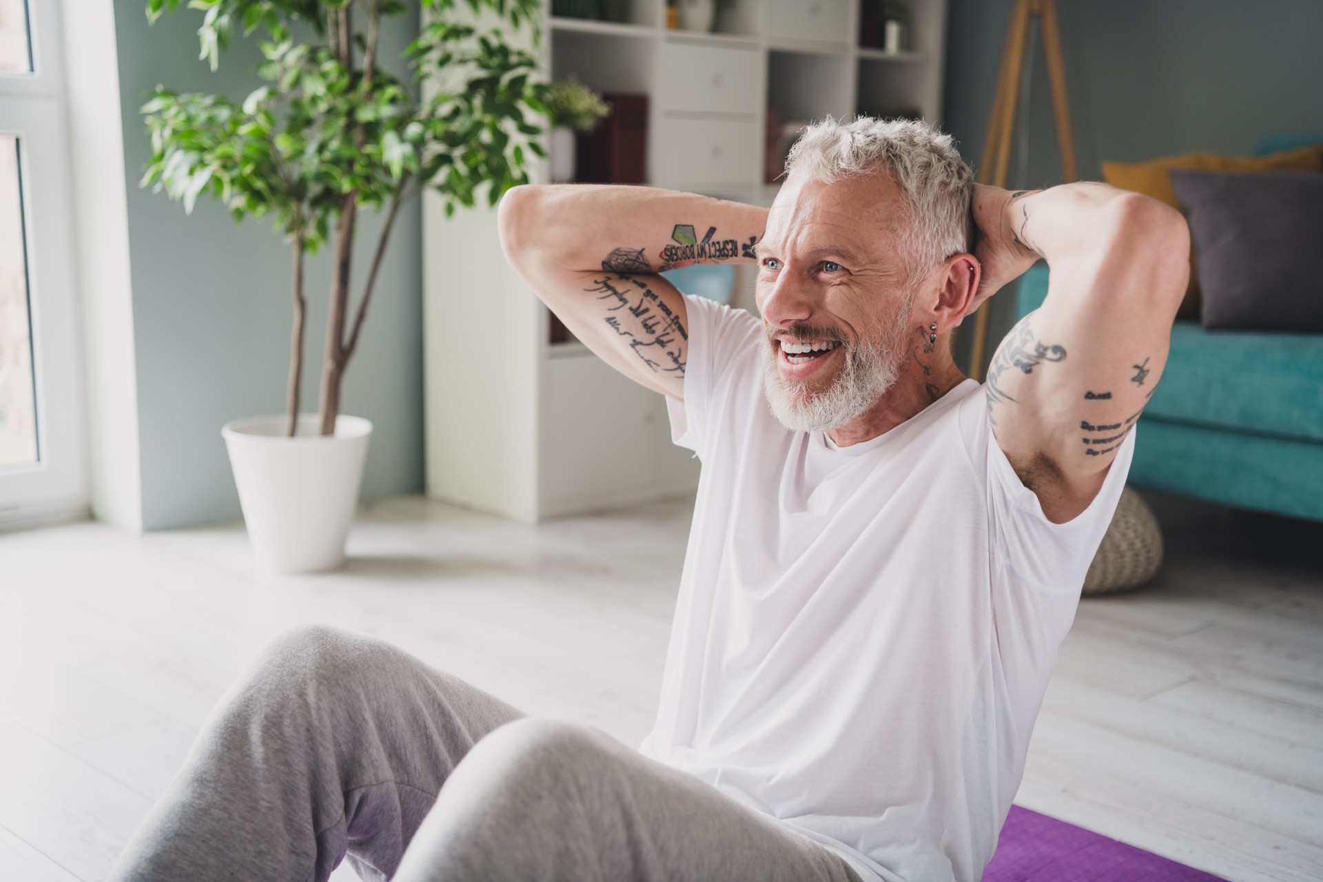 Elderly man engaging in a home workout session showing fitness and active lifestyle indoors