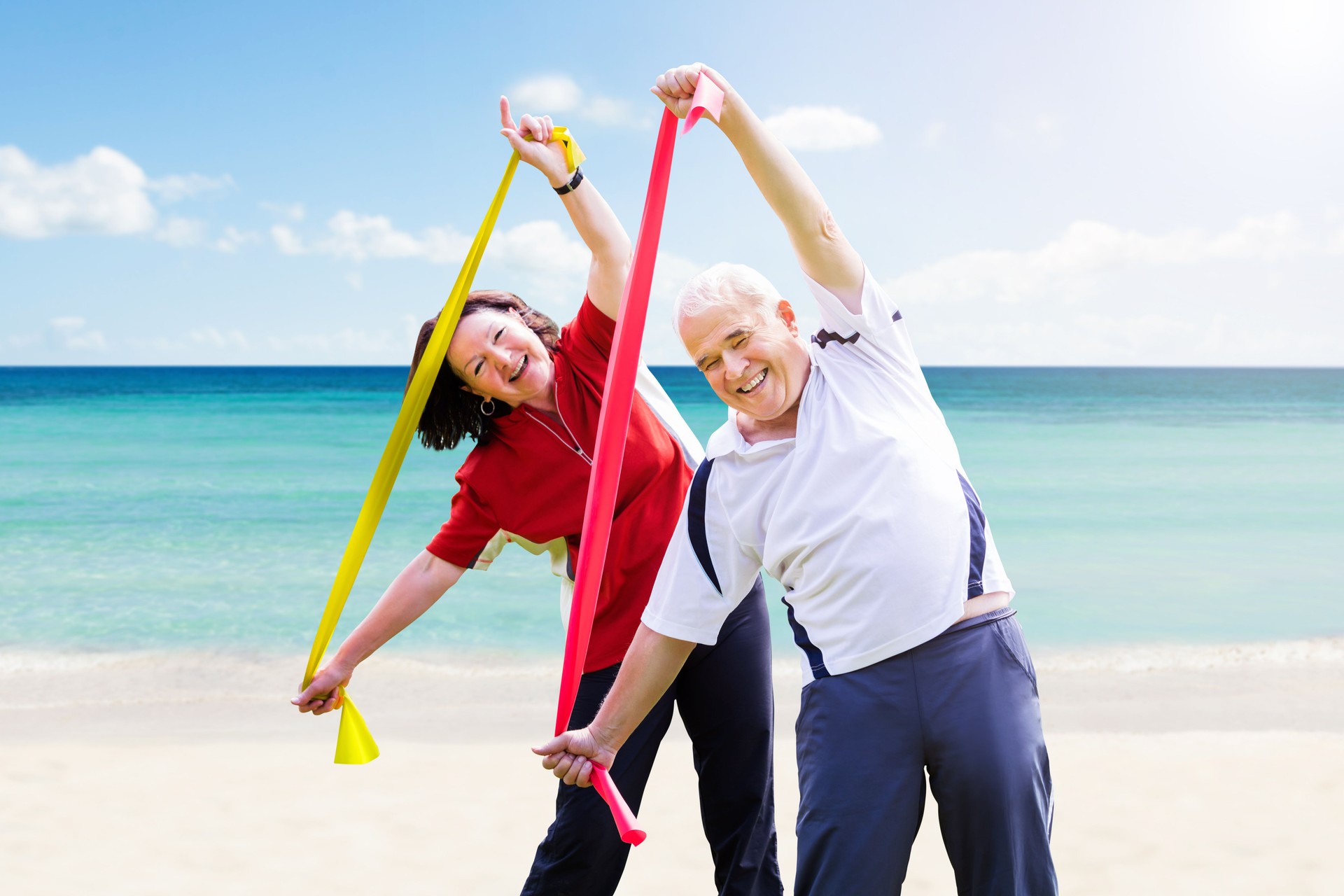 Happy Senior Couple Exercising With Yoga Belt