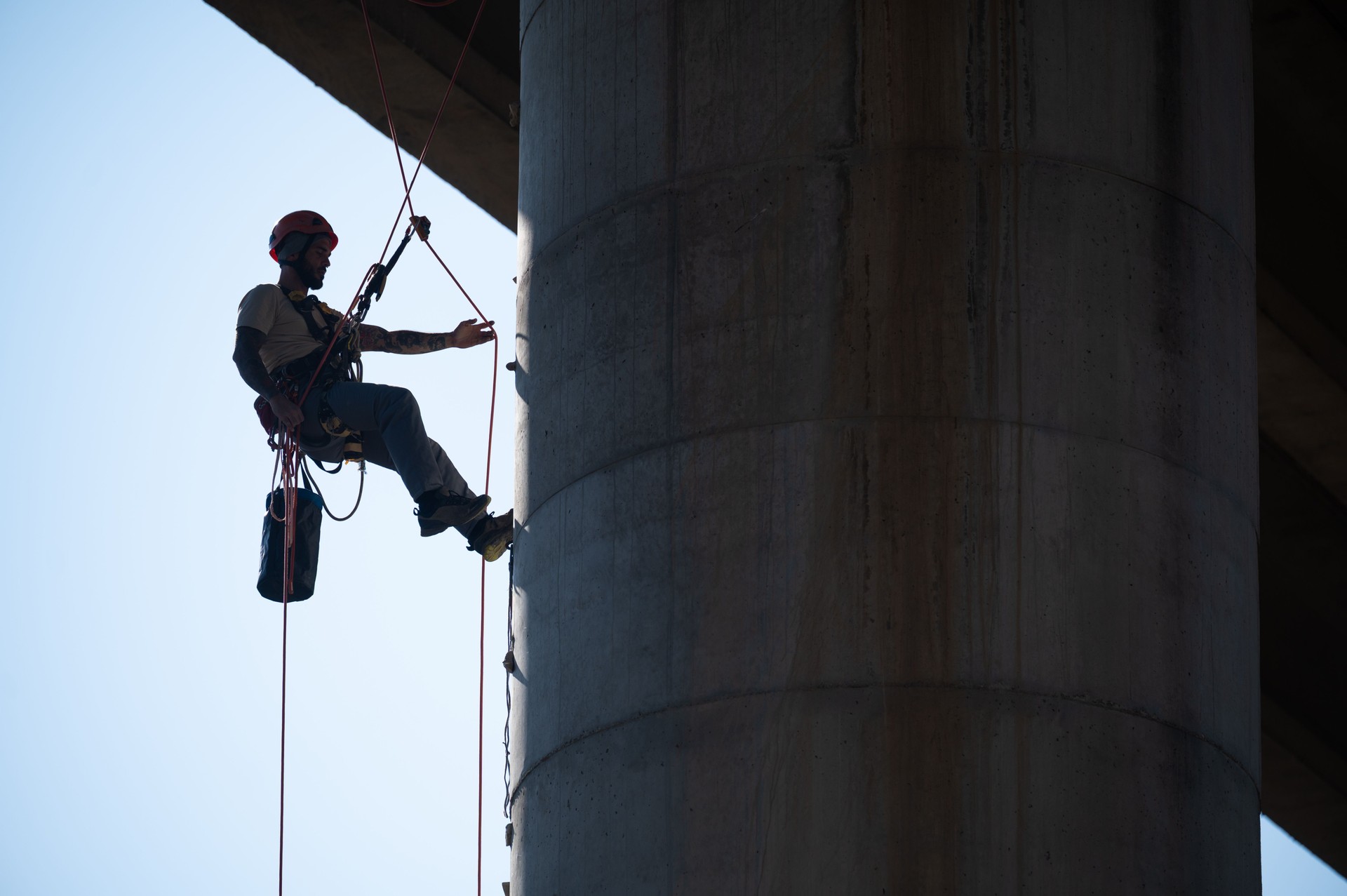 Technician inspecting bridge pylon